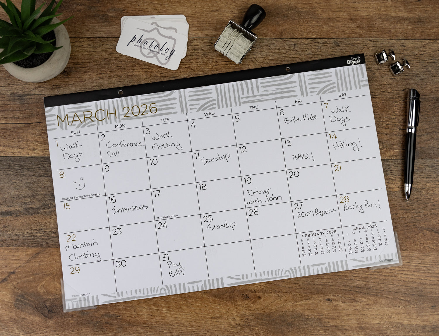 Calendar for March 2026 on a wooden surface with stationery items.
