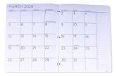 An open three-ring binder planner showing the monthly calendar spread for March 2028 on white pages with blue text and grid lines.