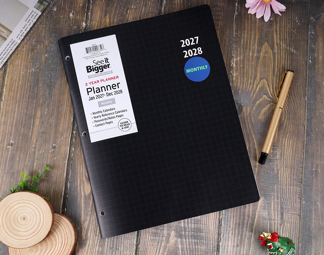 A black grid planner with a white &