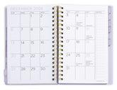 Opened 2026-2027 small planner with floral cover displaying monthly/weekly layout. Small 2026 planner.