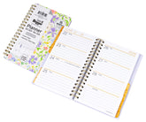 Open planner with floral design on the cover on a white background