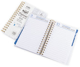 Open daily planner with spiral binding on a white background